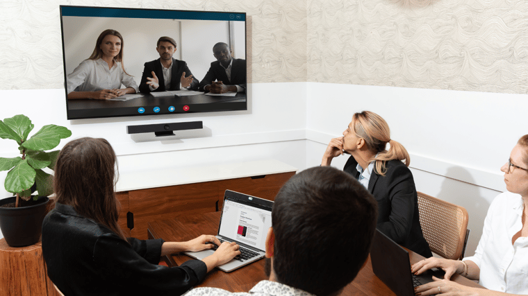 Image of people during a meeting using the Boom Aura Videobar for seamless video conferencing.