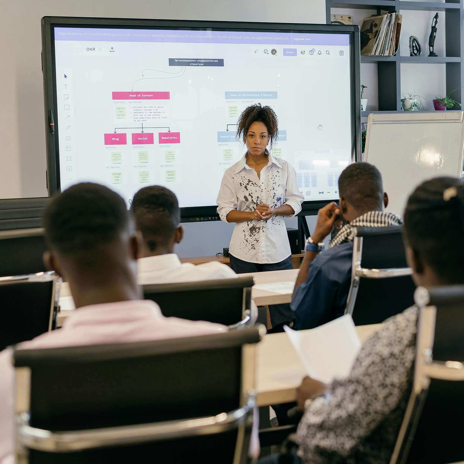 Students listening to a lecture in a modern classroom. Boom Collaboration Equipment makes a hybrid classroom more dynamic.
