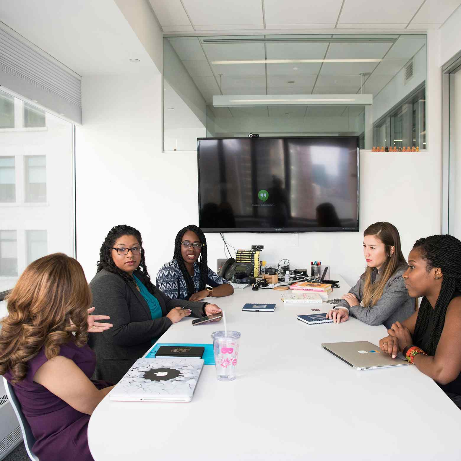 Five women after a meeting using the Boom video conferencing kit, highlighting seamless teamwork.
