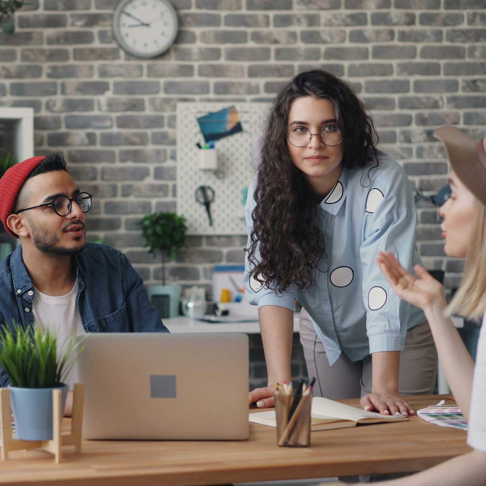 Young professionals in a modern boardroom, collaborating with Boom Collaboration Equipment.