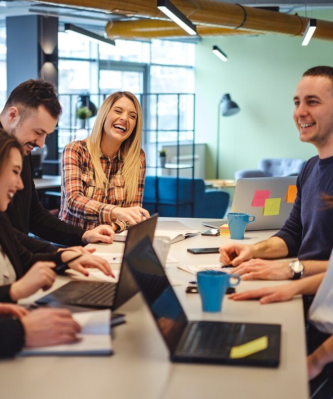 Group of young and smiling coworkers choosing high-quality Boom Collaboration Equipment to unlock better meetings.
