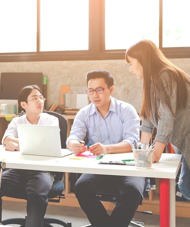 Two groups or two and three people engaging in routine work, showcasing a dynamic and collaborative environment.