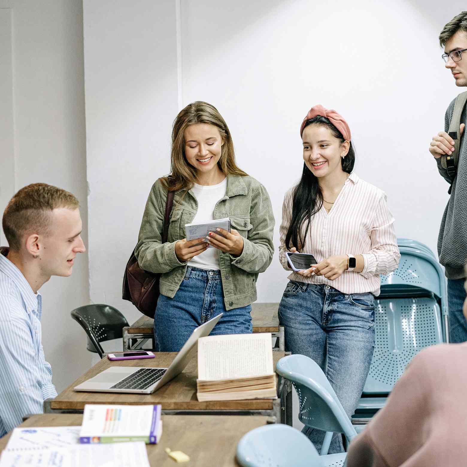 Image showing students talking in a modern meeting room setup with Boom Collaboration Equipment, fostering interactive discussions and collaboration. 