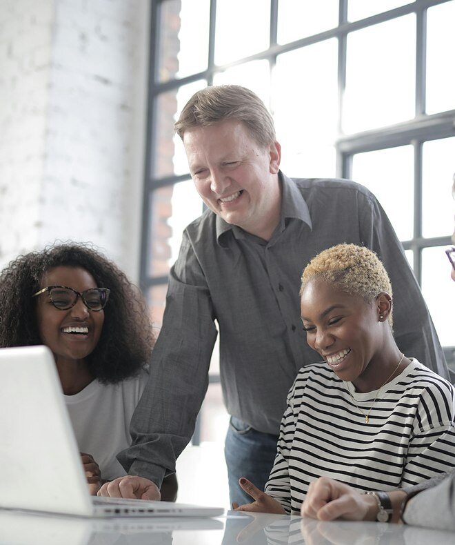 Four co-workers engage in a video conference meeting, optimizing communication and productivity with Boom equipment. 